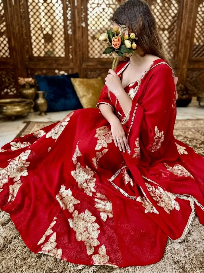 Model in a red lehenga with gold hand embroidery